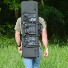 Gray rifle bag worn on back with padded sections, front buckles, and carry strap