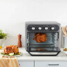 Gray air fryer oven with whole roasted chicken inside, front control panel and glass door