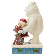 Side view of Jim Shore holiday statue showing Bumble behind Santa and Rudolph