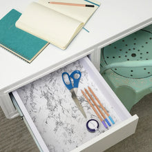 Marble-print shelf liner in a drawer with gray veining on white