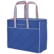 Large blue quilted cooler bag with red, white, and blue striped carry handles