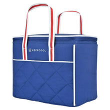 Small blue quilted cooler bag with red, white, and blue striped carry handles
