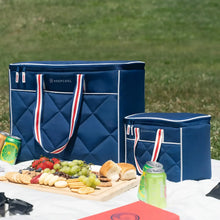 Quilted blue cooler bags set on a table, with striped handles and quilted front panels