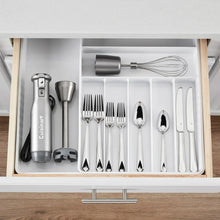 Immersion blender accessories arranged in drawer: whisk, cups, and tools