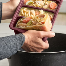 MIU dark red silicone freezer tray used to add frozen soup portions to a pot