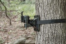 Trail camera flex mount bracket secured to tree with adjustable strap webbing