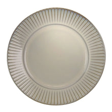 Round stoneware dinner plate with ribbed edge texture and embossed center, white