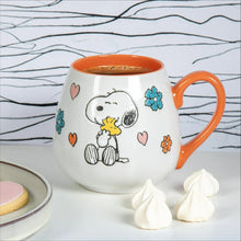 White ceramic mug with orange rim and handle, Peanuts Snoopy mother/baby hearts and flower decals