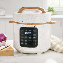 Speckled 6-quart pressure cooker with touch panel showing 06:40