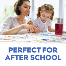 Mother and child at table with red berry juice in a glass for after-school