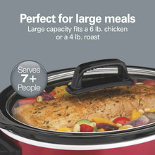 Red slow cooker pot with glass lid and black handle, filled with chicken and vegetables