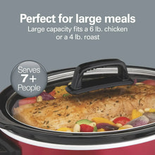 Red slow cooker with glass lid and black handle, filled with chicken and vegetables.