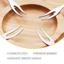 Bamboo board close-up with smooth surface and stainless steel cheese knives