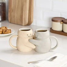 Sculpted hug earthenware mug set of two, white-gray with smiling faces and side arms