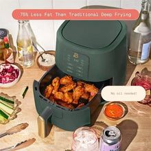 Air fryer with thyme green body, gold handle, open basket with cooked fries