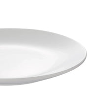 White glazed dinner plate close-up, smooth rim and curved surface