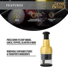 Small gold and black veggie chopper with clear container and black base