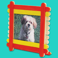 Wood craft sticks arranged into a colorful photo frame with a dog picture