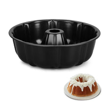 Black carbon steel bundt cake pan with center tube and fluted sides.