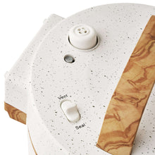 Speckled white pressure cooker lid with vent knob and sealing switch