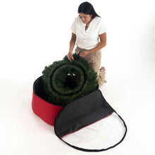 Green wreath being placed into an open red storage bag
