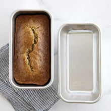Natural aluminum 1 lb loaf pan set with one baked loaf and one empty pan