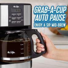 Programmable coffee maker with glass carafe held mid-brew for auto pause