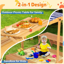 Wooden sandbox playset with picnic table top and striped canopy