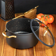 Black speckled non-stick stock pot with gold-tone side handles and a dark lid grip