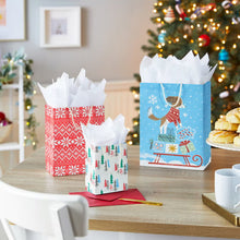 Three Christmas gift bags with snowflake, tree and winter scene prints