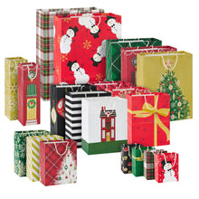 Assortment of holiday gift bags in varied sizes with snowmen, trees, plaid and festive patterns