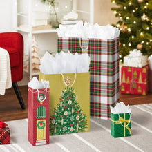 Holiday gift bags with tissue paper, including plaid, Christmas tree and door designs