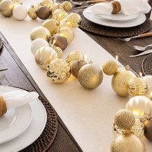 Pre-lit ornament garland with warm LED lights and textured gold, white, and silver baubles
