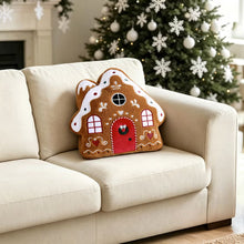 Gingerbread house pillow with a red door and decorative icing details