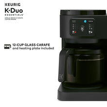 Black Keurig dual coffee maker with front control panel and carafe on warmer