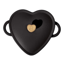Black heart-shaped Dutch oven lid with gold emblem knob and side handles