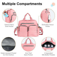 Pink diaper bag with multiple front pockets, side pockets, and separated compartments