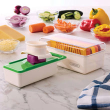 Mandoline slicer set with colored blades and safety holder, on white countertop.
