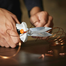 Fiskars PowerCut shears with white handles and orange pivot cutting wire