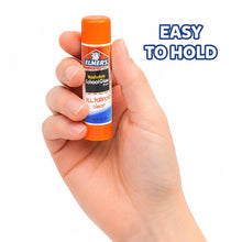 Elmer's washable clear school glue stick held in hand, orange cap