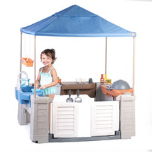 Kids grill play center with blue canopy tent and hanging orange accessory bins