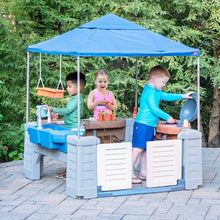Kids grill play center with blue canopy, gray base, and toy kitchen accessories