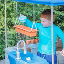 Kids grill play center with blue sink, faucet, and orange ingredient basket