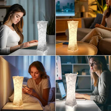 Tall fabric table lamp with textured white shade, warm light glowing