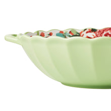 Ceramic serving bowl with mint green exterior, side handle, and red floral interior