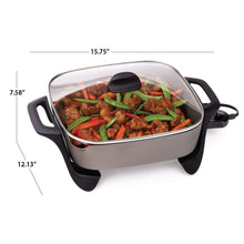 Ceramic electric skillet with glass lid and black handles, with cooked meat and peppers