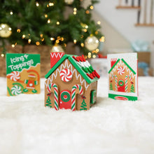 Wooden gingerbread house play set with three house parts and an icing toppings pack
