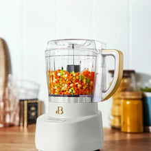 Drew Barrymore 3-cup food chopper filled with diced vegetables in clear bowl