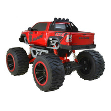 Red RC 4x4 monster truck with roll cage, orange shocks, and large tread tires