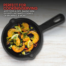 Small cast iron skillet with cooked vegetables and herbs, seen from above